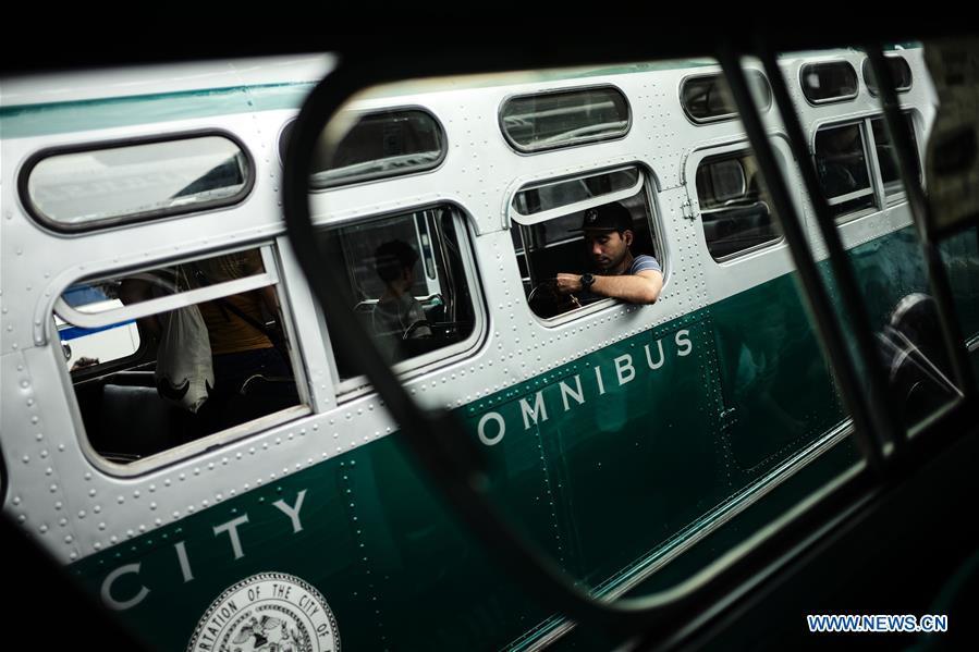 A man sits inside a vintage bus during the 25th Annual Bus Festival in New York, the United States, on Oct. 7, 2018. The New York Transit Museum held its 25th annual bus festival on Sunday. The buses on display represent about 80 years of surface transit history in New York City. The oldest bus at the festival, Bus 1263, is a double-decker bus that was purchased by the Fifth Avenue Bus Company in 1930. (Xinhua/Li Muzi)
