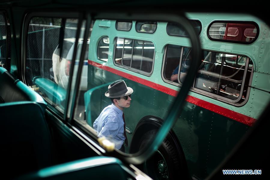 A man takes photos of a vintage bus during the 25th Annual Bus Festival in New York, the United States, on Oct. 7, 2018. The New York Transit Museum held its 25th annual bus festival on Sunday. The buses on display represent about 80 years of surface transit history in New York City. The oldest bus at the festival, Bus 1263, is a double-decker bus that was purchased by the Fifth Avenue Bus Company in 1930. (Xinhua/Li Muzi)