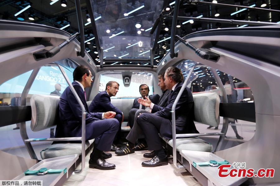 French President Emmanuel Macron, Carlos Ghosn the CEO of French carmaker Renault, and French politician Luc Chatel speak at the the Renault stand during an official visit at the Paris Motor Show in Paris, France October 3, 2018. (Photo/Agencies)