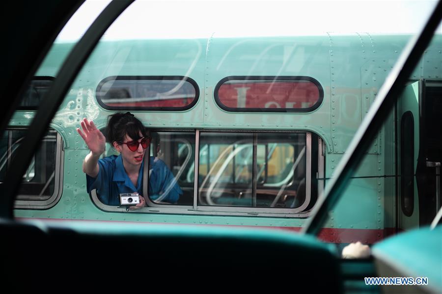 A woman poses for a photo inside a vintage bus during the 25th Annual Bus Festival in New York, the United States, on Oct. 7, 2018. The New York Transit Museum held its 25th annual bus festival on Sunday. The buses on display represent about 80 years of surface transit history in New York City. The oldest bus at the festival, Bus 1263, is a double-decker bus that was purchased by the Fifth Avenue Bus Company in 1930. (Xinhua/Li Muzi)