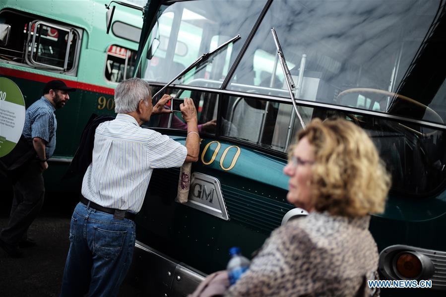A man steps on a vintage bus during the 25th Annual Bus Festival in New York, the United States, on Oct. 7, 2018. The New York Transit Museum held its 25th annual bus festival on Sunday. The buses on display represent about 80 years of surface transit history in New York City. The oldest bus at the festival, Bus 1263, is a double-decker bus that was purchased by the Fifth Avenue Bus Company in 1930. (Xinhua/Li Muzi)