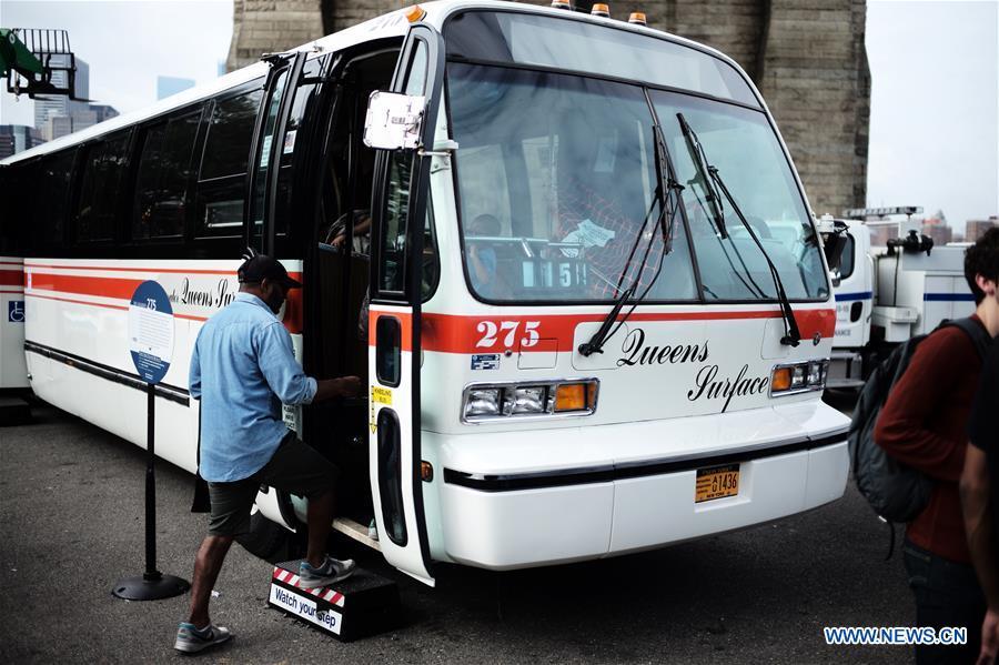 A woman poses for a photo inside a vintage bus during the 25th Annual Bus Festival in New York, the United States, on Oct. 7, 2018. The New York Transit Museum held its 25th annual bus festival on Sunday. The buses on display represent about 80 years of surface transit history in New York City. The oldest bus at the festival, Bus 1263, is a double-decker bus that was purchased by the Fifth Avenue Bus Company in 1930. (Xinhua/Li Muzi)