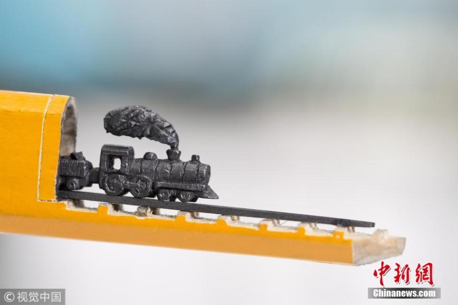 A artwork carved from the tip of pencil lead, by  Turkish artist Nihat Ozcan. Ozcan is one of the rare pencil carving artists in the world. He carves figures in miniature on the tips of pencils. (Photo/CFP)