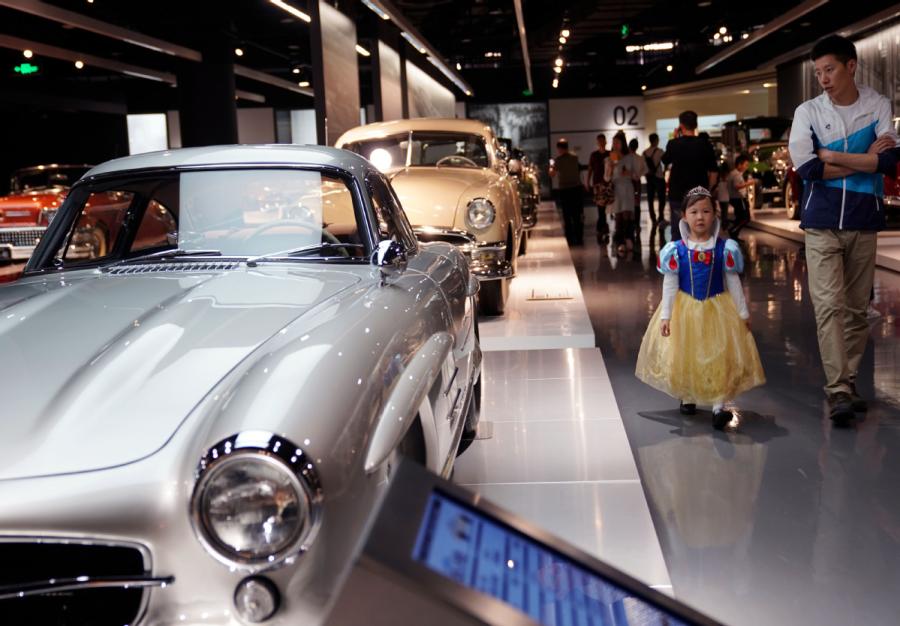 A girl, accompanied by her father, visits Shanghai Auto Museum in Shanghai on Oct. 7, 2018. (Photo/Xinhua)