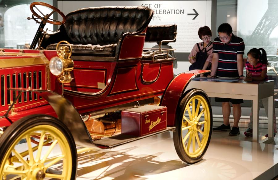 A girl, accompanied by her parents, visits Shanghai Auto Museum in Shanghai on Oct. 7, 2018. (Photo/Xinhua)