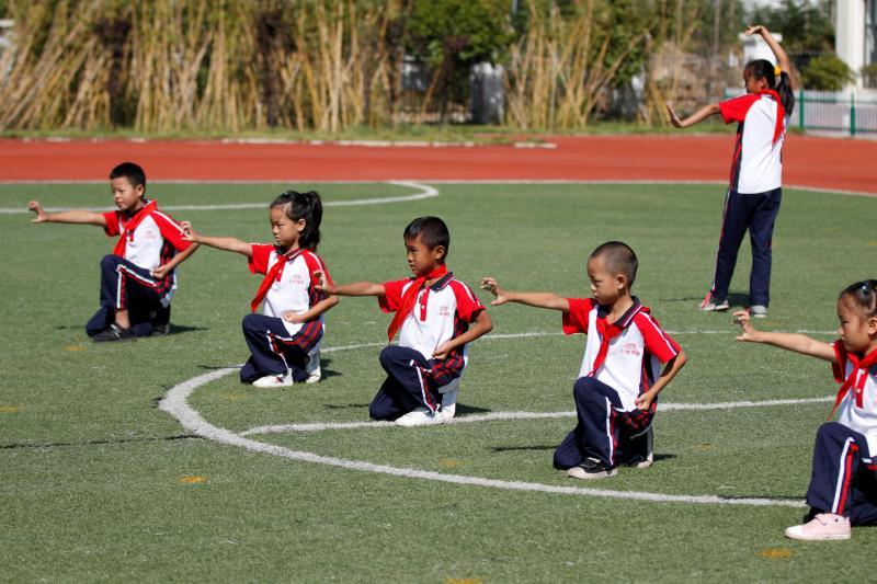 Xiaogang School students in a part-time martial arts class do exercises on Sept. 27. (Photo/chinadaily.com.cn)