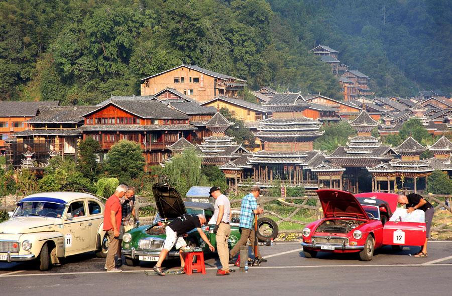 Drivers check the condition of their cars at a parking area, Oct 8, 2018. The drivers, the eldest aged 84, departed Germany on Aug. 19. (Photo provided to chinadaily.com.cn)