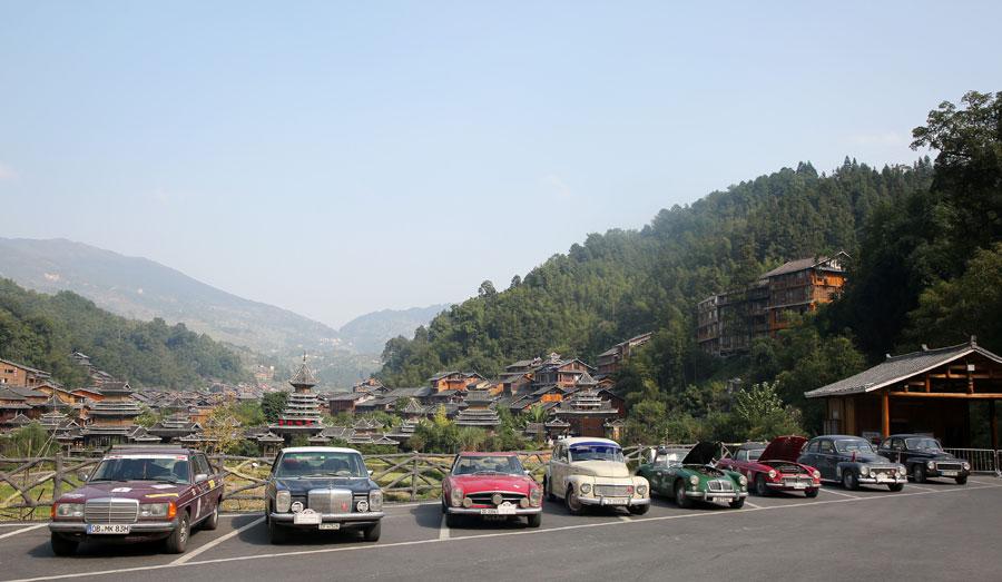 Vintage cars park at a Dong ethnic village in Liping, Southwest China\'s Guizhou province on Oct. 8, 2018. The trip was initiated by 34 drivers from Germany and Switzerland. (Photo provided to chinadaily.com.cn)