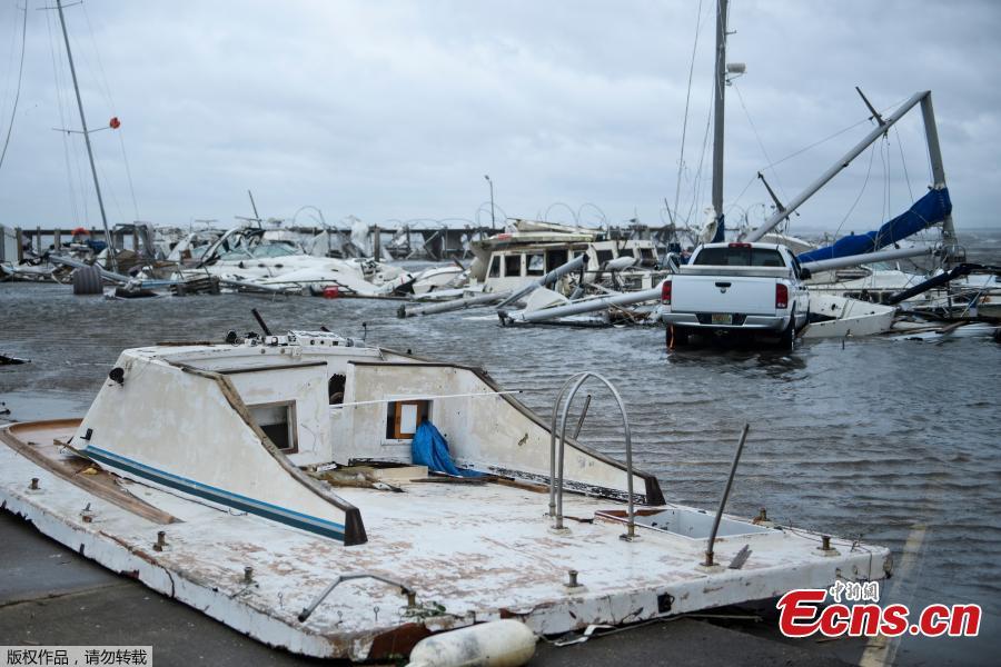 Damaged boats and a truck are seen in a marina after Hurricane Michael October 10, 2018 in Panama City, Florida. Michael slammed into the Florida coast on October 10 as the most powerful storm to hit the southern US state in more than a century as officials warned it could wreak \
