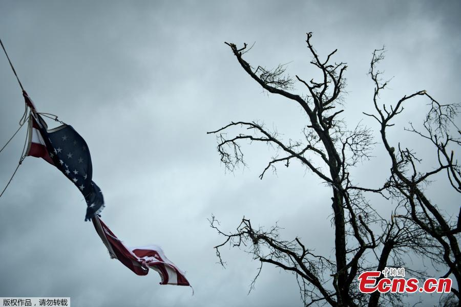 An American flag is torn during Hurricane Michael October 10, 2018 in Panama City, Florida. Michael slammed into the Florida coast on October 10 as the most powerful storm to hit the southern US state in more than a century as officials warned it could wreak \