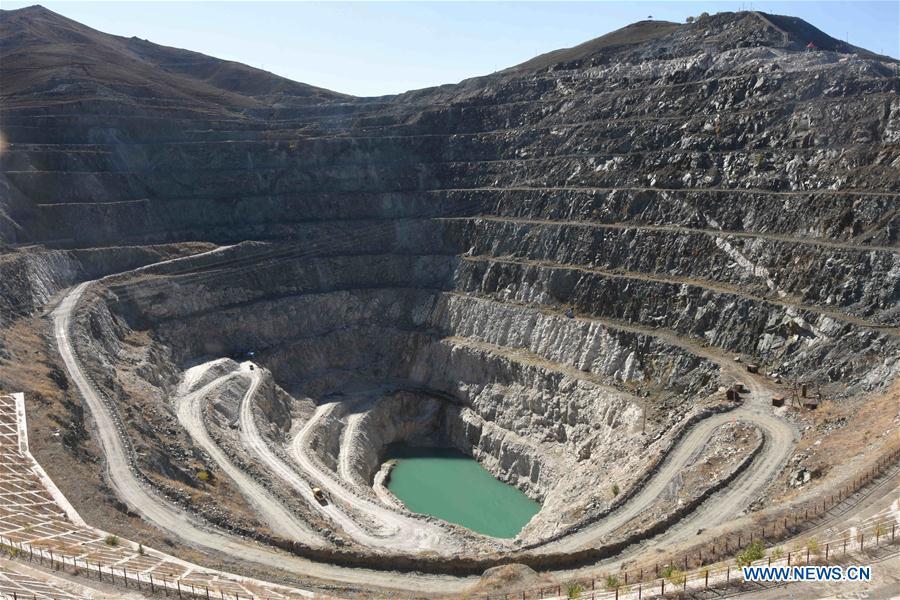 Photo taken on Oct. 10, 2018 shows the scenery of a mine crater at the Keketuohai UNESCO Global Geopark in northwest China\'s Xinjiang Uygur Autonomous Region. Xinjiang officially opened its first geopark in Keketuohai on Wednesday. Located south of the Altay Mountains and at the source of the Irtysh River, the park covers more than 2,300 square kilometers. Visitors will be able to enjoy breathtaking views including the Irtysh Grand Canyon, a huge mine crater, lakes, mountains, a waterfall, fossils and rivers. UNESCO announced eight new global geoparks in May last year, including Keketuohai. (Xinhua/Zhang Xiaolong)