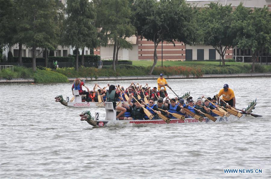 Contestants paddle during a dragon boat race in Houston, Texas, the United States, Oct. 13, 2018. The 15th annual Gulf Coast International Dragon Boat Regatta kicked off on Saturday in Sugar Land in Southwest Houston, Texas, the United States, aiming to promote the tradition and share this aspect of Asian culture. (Xinhua/Sun Jiayi)