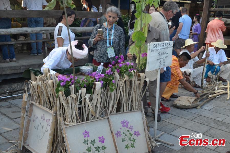 Women of Dai ethnic group show traditional paper-making craft, using a kind of bark as raw material, at Mengtuan Village in Lincang City, Southwest China’s Yunnan Province, Oct. 15, 2018. The paper-making technique dated from 600 years ago and was listed as a national intangible cultural heritage in 2006. (Photo: China News Service/Miao Chao)