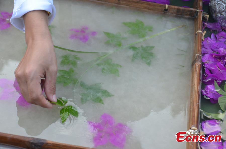 Women of Dai ethnic group show traditional paper-making craft, using a kind of bark as raw material, at Mengtuan Village in Lincang City, Southwest China’s Yunnan Province, Oct. 15, 2018. The paper-making technique dated from 600 years ago and was listed as a national intangible cultural heritage in 2006. (Photo: China News Service/Miao Chao)