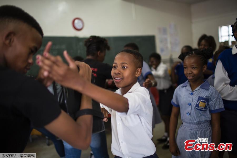 Girls practice self-defense methods during a session with NGO Action Breaks Silence (ABS) called \'Empowerment through Self-defense for women and girls\' which aims to create a world free form fear of gender based violence, at Mbuyisa Makhubu Primary School in the area of Orlando West, in the South African township of Soweto, on October 10, 2018. (Photo/Agencies)