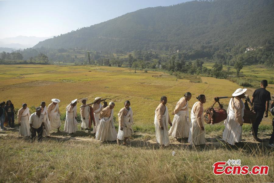 People in traditional costumes celebrate the Shikali festival in Patan, Nepal, Oct. 15, 2018. The festival is observed by people from the ethnic Newar community. During the festival, people wear masks representing different Hindu gods and goddesses, and dance and pray for happiness. (Photo/China News Service)