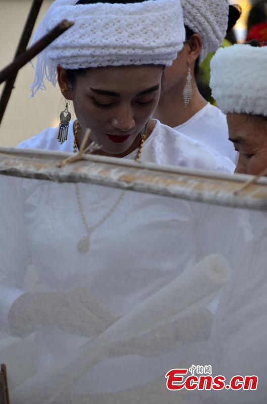 Women of Dai ethnic group show traditional paper-making craft, using a kind of bark as raw material, at Mengtuan Village in Lincang City, Southwest China’s Yunnan Province, Oct. 15, 2018. The paper-making technique dated from 600 years ago and was listed as a national intangible cultural heritage in 2006. (Photo: China News Service/Miao Chao)