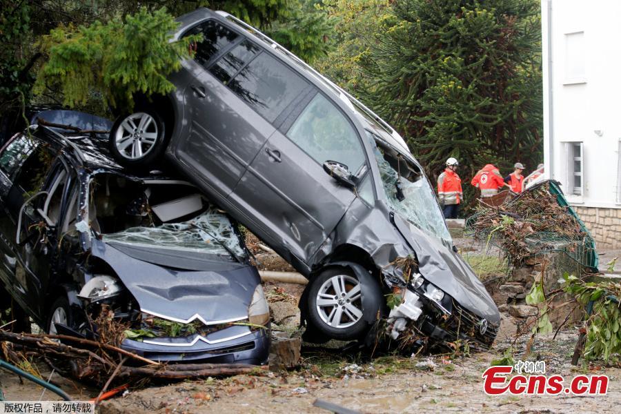 General view shows a damaged car near a swimming pool as clean-up operations continue the day after some of the worst flash floods in a century turned rivers into raging torrents that engulfed homes and swept away cars hit the southwestern Aude district of France, in Conques, France, Oct. 16, 2018. At least 12 people died. (Photo/Agencies)