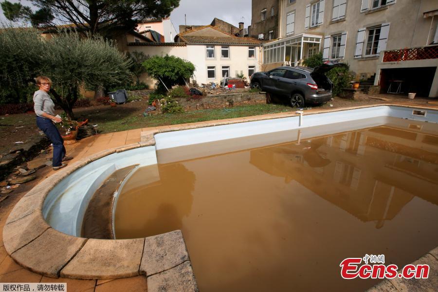 General view shows a damaged car near a swimming pool as clean-up operations continue the day after some of the worst flash floods in a century turned rivers into raging torrents that engulfed homes and swept away cars hit the southwestern Aude district of France, in Conques, France, Oct. 16, 2018. At least 12 people died. (Photo/Agencies)