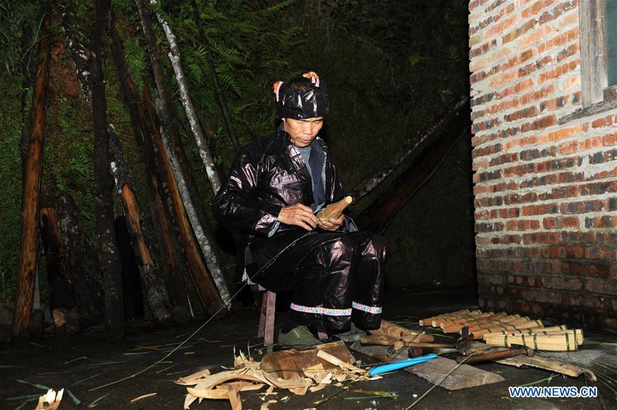 Craftsman Liang Jianzhong whittles a sound hole on the tube of Lusheng at Jinying Village in Congjiang County of Miao and Dong Autonomous Prefecture of Qiandongnan, southwest China\'s Guizhou Province, on Oct. 16, 2018. Lusheng is an ethnic musical instrument with multiple bamboo pipes set into a wooden blowing tube. It is popular among the people of some ethnic groups living in southwestern China. Jinying Village, known for making Lusheng, still keeps the traditional Lusheng making techniques which include over 30 steps such as choosing material, installing reed and whittling sound hole. People often play the Lusheng while gathering to celebrate some major festivals. (Xinhua/Yang Wenbin)