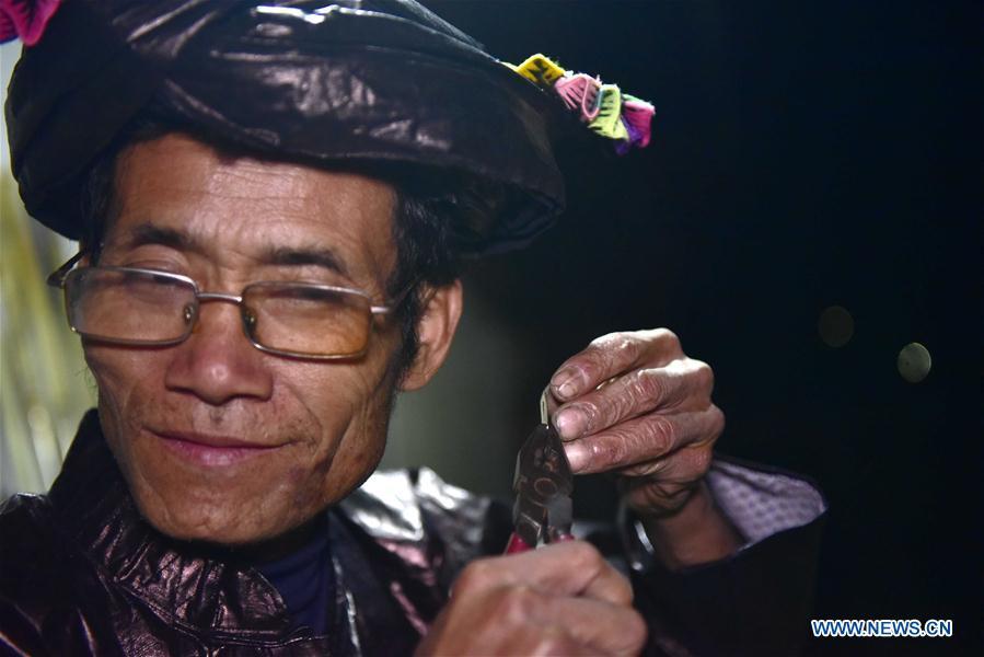 Craftsman Liang Zeguang tests the tone of a reed for Lusheng at Jinying Village in Congjiang County of Miao and Dong Autonomous Prefecture of Qiandongnan, southwest China\'s Guizhou Province, on Oct. 16, 2018. Lusheng is an ethnic musical instrument with multiple bamboo pipes set into a wooden blowing tube. It is popular among the people of some ethnic groups living in southwestern China. Jinying Village, known for making Lusheng, still keeps the traditional Lusheng making techniques which include over 30 steps such as choosing material, installing reed and whittling sound hole. People often play the Lusheng while gathering to celebrate some major festivals. (Xinhua/Wu Dejun)