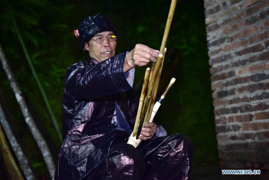 Craftsman Liang Jianzhong installs bamboo pipes on a wooden blowing tube at Jinying Village in Congjiang County of Miao and Dong Autonomous Prefecture of Qiandongnan, southwest China\'s Guizhou Province, on Oct. 16, 2018. Lusheng is an ethnic musical instrument with multiple bamboo pipes set into a wooden blowing tube. It is popular among the people of some ethnic groups living in southwestern China. Jinying Village, known for making Lusheng, still keeps the traditional Lusheng making techniques which include over 30 steps such as choosing material, installing reed and whittling sound hole. People often play the Lusheng while gathering to celebrate some major festivals. (Xinhua/Wu Dejun)