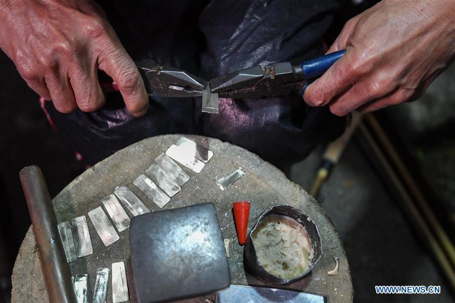Craftsman Liang Zeguang makes reeds for Lusheng at Jinying Village in Congjiang County of Miao and Dong Autonomous Prefecture of Qiandongnan, southwest China\'s Guizhou Province, on Oct. 16, 2018. Lusheng is an ethnic musical instrument with multiple bamboo pipes set into a wooden blowing tube. It is popular among the people of some ethnic groups living in southwestern China. Jinying Village, known for making Lusheng, still keeps the traditional Lusheng making techniques which include over 30 steps such as choosing material, installing reed and whittling sound hole. People often play the Lusheng while gathering to celebrate some major festivals. (Xinhua/Chen Yehua)