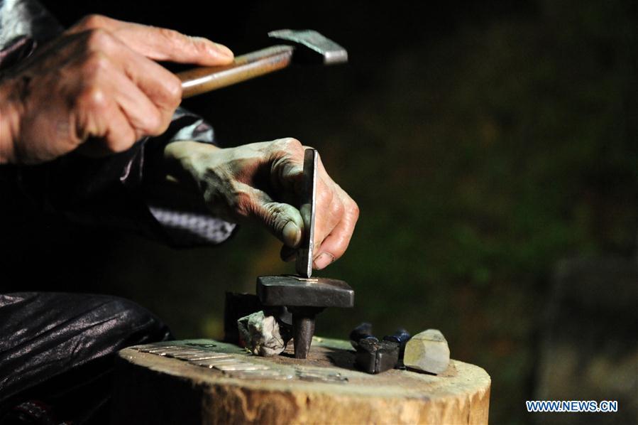 Craftsman Liang Zeguang makes reeds for Lusheng at Jinying Village in Congjiang County of Miao and Dong Autonomous Prefecture of Qiandongnan, southwest China\'s Guizhou Province, on Oct. 16, 2018. Lusheng is an ethnic musical instrument with multiple bamboo pipes set into a wooden blowing tube. It is popular among the people of some ethnic groups living in southwestern China. Jinying Village, known for making Lusheng, still keeps the traditional Lusheng making techniques which include over 30 steps such as choosing material, installing reed and whittling sound hole. People often play the Lusheng while gathering to celebrate some major festivals. (Xinhua/Yang Wenbin)