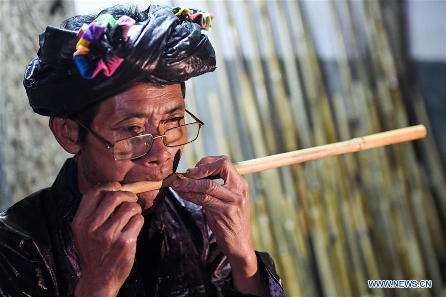 Craftsman Liang Zeguang tests the tone of a reed fitted in a bamboo pipe at Jinying Village in Congjiang County of Miao and Dong Autonomous Prefecture of Qiandongnan, southwest China\'s Guizhou Province, on Oct. 16, 2018. Lusheng is an ethnic musical instrument with multiple bamboo pipes set into a wooden blowing tube. It is popular among the people of some ethnic groups living in southwestern China. Jinying Village, known for making Lusheng, still keeps the traditional Lusheng making techniques which include over 30 steps such as choosing material, installing reed and whittling sound hole. People often play the Lusheng while gathering to celebrate some major festivals. (Xinhua/Chen Yehua)