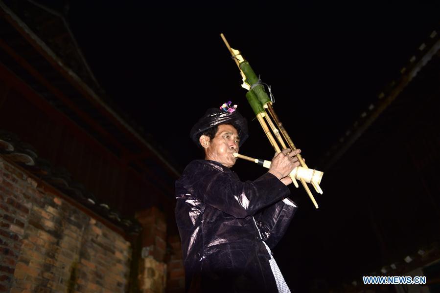 Craftsman Liang Zeguang tries a finished Lusheng at Jinying Village in Congjiang County of Miao and Dong Autonomous Prefecture of Qiandongnan, southwest China\'s Guizhou Province, on Oct. 16, 2018. Lusheng is an ethnic musical instrument with multiple bamboo pipes set into a wooden blowing tube. It is popular among the people of some ethnic groups living in southwestern China. Jinying Village, known for making Lusheng, still keeps the traditional Lusheng making techniques which include over 30 steps such as choosing material, installing reed and whittling sound hole. People often play the Lusheng while gathering to celebrate some major festivals. (Xinhua/Wu Dejun)