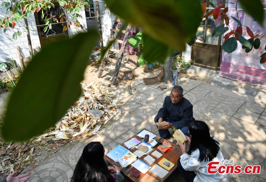 Farmer Jia Zengwen shows a diary he began to write 60 years ago at his home in Niujia Village, Gaocheng City, North China’s Hebei Province, Oct. 18, 2018. Jia has filled 108 diaries over the years, and they include records of his first time receiving the subsidy, a medical insurance claim, and the pension. The diaries also provide a record of the change that has taken place in his rural home over the past 40 years of reform and opening up. (Photo: China News Service/Zhai Yujia)
