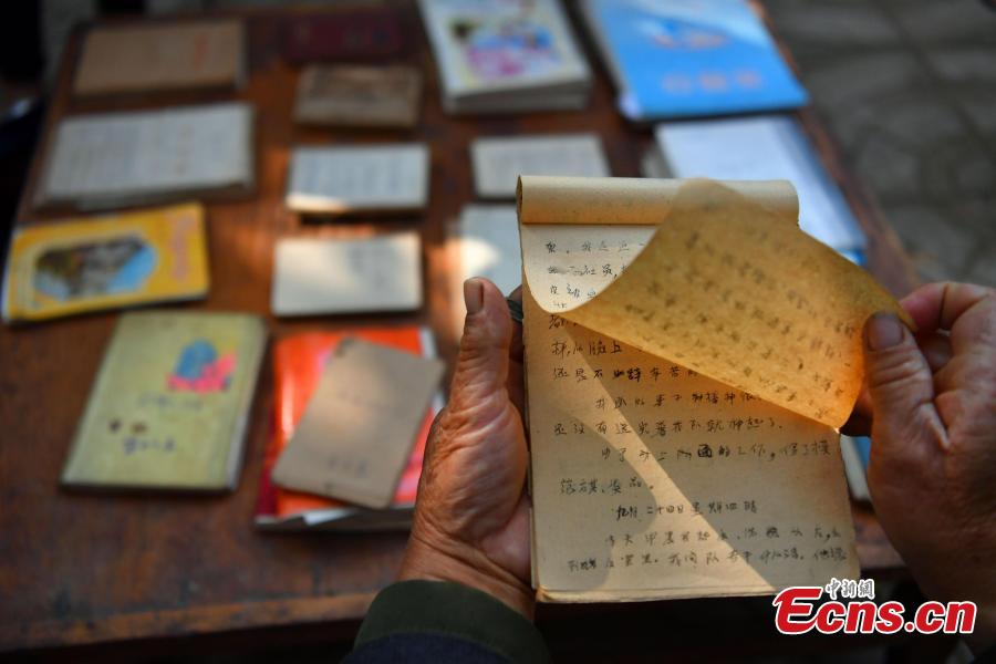 Farmer Jia Zengwen shows a diary he began to write 60 years ago at his home in Niujia Village, Gaocheng City, North China’s Hebei Province, Oct. 18, 2018. Jia has filled 108 diaries over the years, and they include records of his first time receiving the subsidy, a medical insurance claim, and the pension. The diaries also provide a record of the change that has taken place in his rural home over the past 40 years of reform and opening up. (Photo: China News Service/Zhai Yujia)