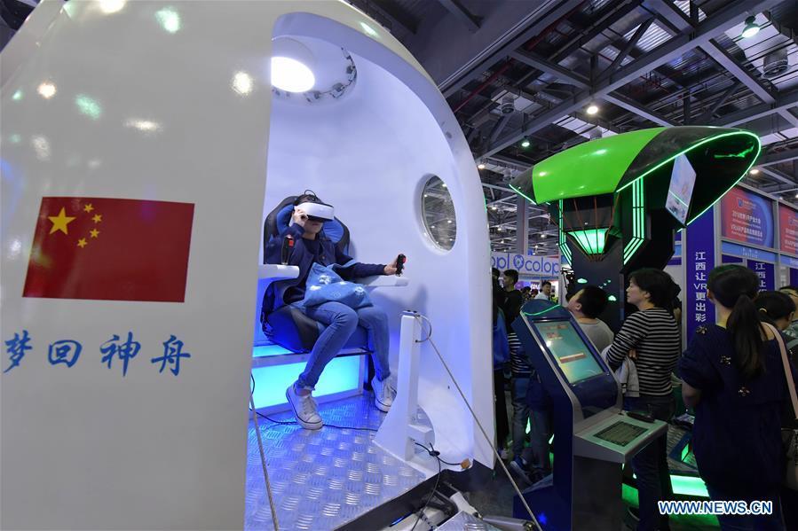 A visitor wears a VR (virtual reality) device to learn about the space during the 2018 World Conference on VR Industry in Nanchang, east China\'s Jiangxi Province, Oct. 19, 2018. The 2018 World Conference on VR Industry opened here on Friday. The three-day event attracts more than 150 global exhibitors in the virtual reality field. (Xinhua/Peng Zhaozhi)