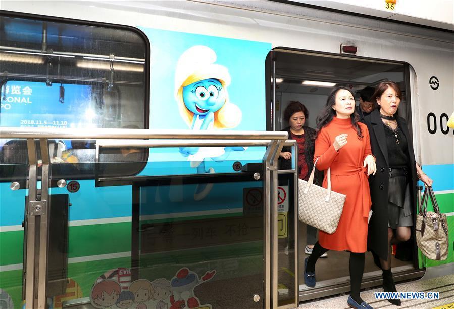 Passengers get off a China-Belgium theme train of Shanghai Metro Line 2 bearing a character image from Belgian comic \