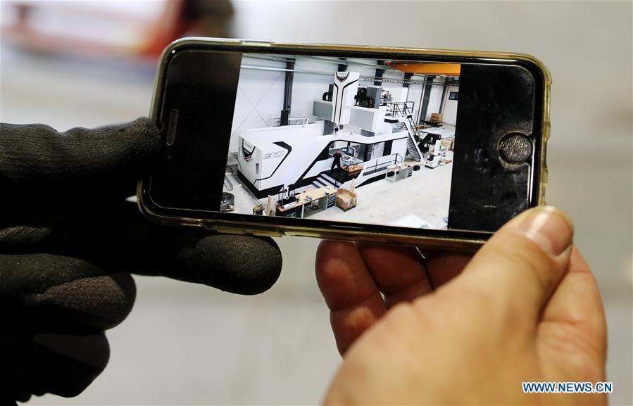 German engineer Martin Holzheid shows a design sketch of Taurus milling machine in Shanghai, east China, Oct. 17, 2018. Preliminary assembly of the milling machine, which will be the largest exhibit to be on show at China\'s upcoming import expo, was finished here on Monday. The exhibit is expected to cover 200 square meters of exhibiting space during the expo, which is scheduled to be held in Shanghai on Nov. 5-10. (Xinhua/Fang Zhe)