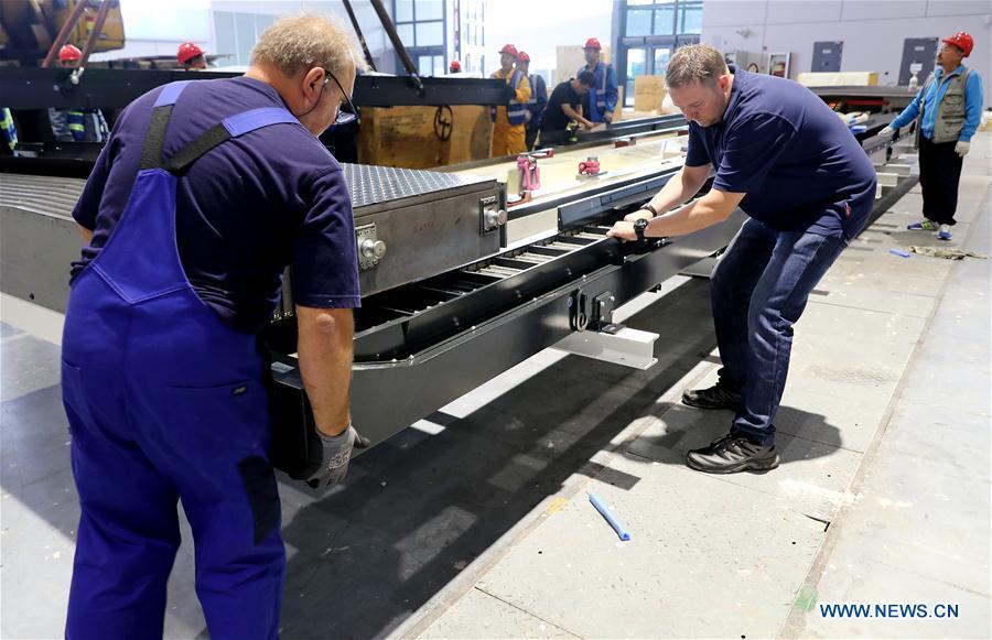 German engineers Martin Holzheid (L) and Lucas Rebhan work at the assembly site of Taurus milling machine in Shanghai, east China, Oct. 17, 2018. Preliminary assembly of the milling machine, which will be the largest exhibit to be on show at China\'s upcoming import expo, was finished here on Monday. The exhibit is expected to cover 200 square meters of exhibiting space during the expo, which is scheduled to be held in Shanghai on Nov. 5-10. (Xinhua/Fang Zhe)