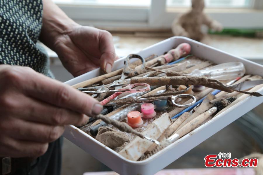 Clay sculpture enthusiast Zhao Tiejun shows his tools to make creations featuring past rural life and farming traditions in his home in Pingliang City, Northwest China’s Gansu Province, Oct. 23, 2018. Zhao has been fascinated with the hobby of making clay figurines for two decades as he believes the handicraft can help younger generation learn about the countryside life now increasingly transformed. (Photo: China News Service/Zheng Bing)