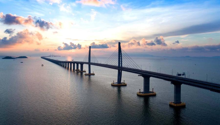 An aerial view of the Hong Kong-Zhuhai-Macao Bridge. At 55 kilometers, the bridge is the world\'s longest sea-spanning structure. (Photo/HZMB AUTHORITY)

As the Hong Kong-Zhuhai-Macao Bridge prepares to open to traffic on Wednesday, here is what you need to know about the world\'s longest sea-crossing bridge.

1. Vehicles that could use the bridge

Among the vehicle types authorized to use the Hong Kong-Zhuhai-Macao Bridge, shuttle buses will run only between the ports of Hong Kong and Zhuhai/Macao, not crossing any boundaries.

Cross-boundary coaches via HZMB will operate similarly to current coaches that run between the Chinese mainland and the two special administrative regions through existing ports, such as the Shenzhen Bay Port.

Cross-boundary private cars under quotas for existing boundary crossings (i.e. Shenzhen Bay and Lok Ma Chau) will be allowed to use the Hong Kong-Zhuhai-Macao Bridge without additional procedures on a trial basis.

According to figures from the Transport Department in Hong Kong, the number of Hong Kong cross-boundary private cars issued with valid Closed Road Permits (CRP) was 30,400 as of 2017.

The number of mainland cross-border boundary cars with such permits is more than 20,000, according to the bridge operator, HZMB Authority.

Governments in Hong Kong and the mainland have both promised flexible adjustment of quotas for cross- boundary private cars in accordance with the traffic volume after the bridge opens.