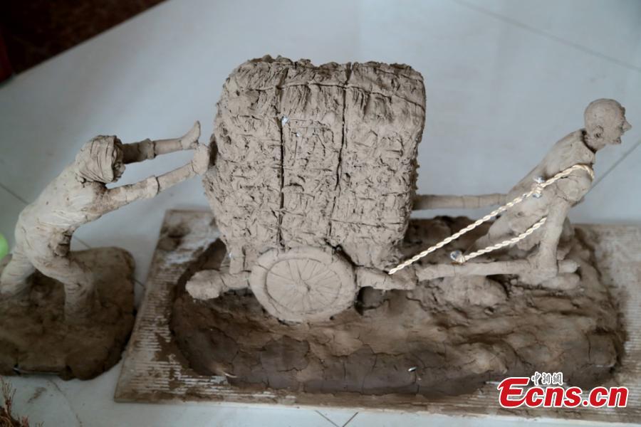 Clay sculpture enthusiast Zhao Tiejun shows his creations featuring past rural life and farming traditions in his home in Pingliang City, Northwest China’s Gansu Province, Oct. 23, 2018. Zhao has been fascinated with the hobby of making clay figurines for two decades as he believes the handicraft can help younger generation learn about the countryside life now increasingly transformed. (Photo: China News Service/Zheng Bing)