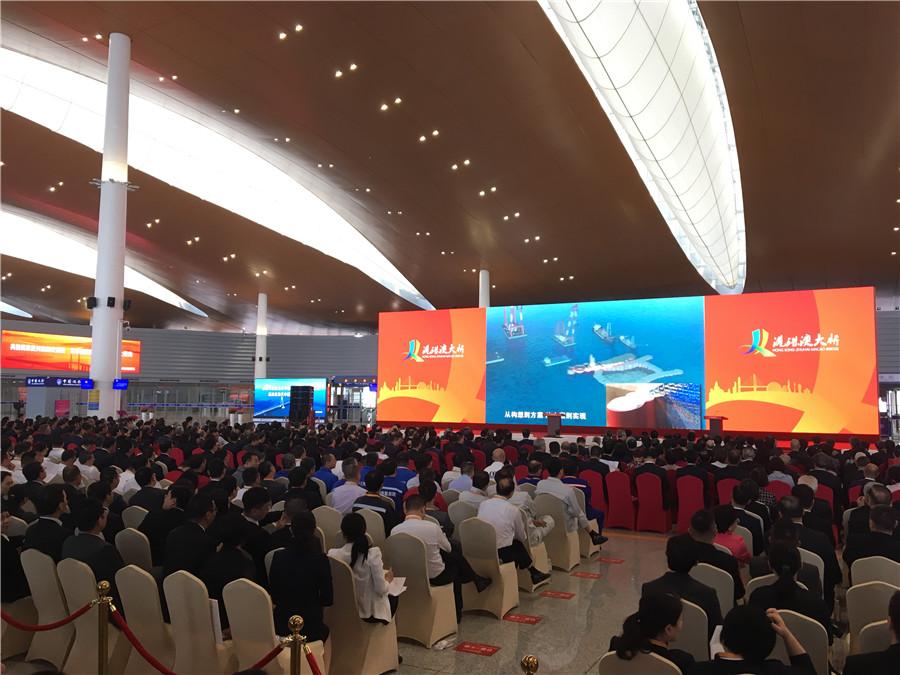 The attendees of the Hong Kong-Zhuhai-Macao Opening Ceremony wait patiently in their seats as the event will soon begin Tuesday morning. （Photo by He Shusi/China Daily）