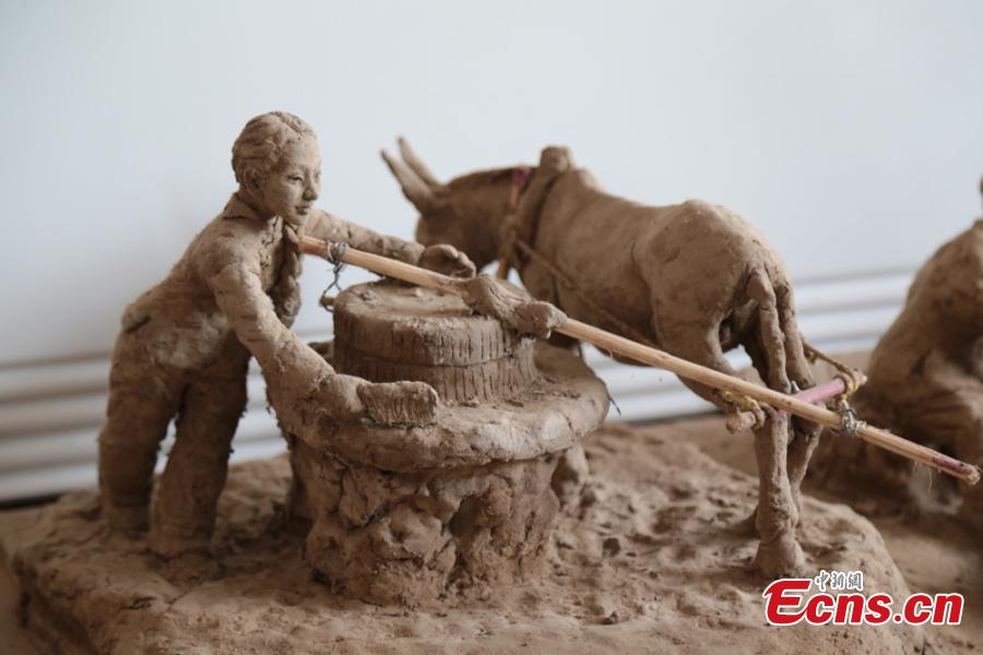 Clay sculpture enthusiast Zhao Tiejun shows his creations featuring past rural life and farming traditions in his home in Pingliang City, Northwest China’s Gansu Province, Oct. 23, 2018. Zhao has been fascinated with the hobby of making clay figurines for two decades as he believes the handicraft can help younger generation learn about the countryside life now increasingly transformed. (Photo: China News Service/Zheng Bing)