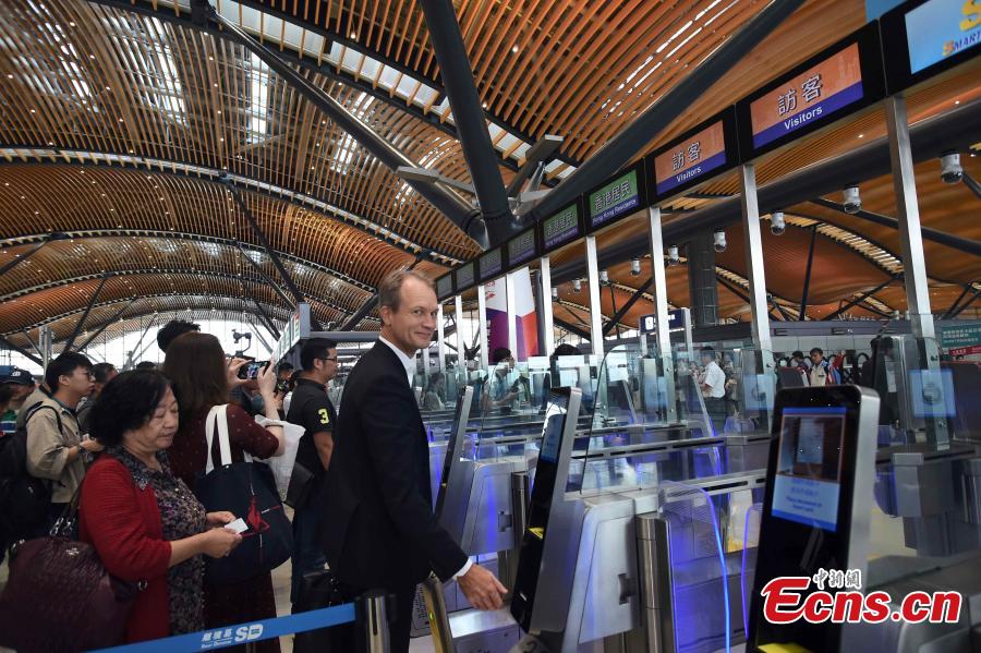 Passengers wait at the Passenger Clearance Building in Hong Kong to board coaches that will pass over the Hong Kong-Zhuhai-Macao Bridge, Oct. 24, 2018. (Photo: China News Service/Sheung Man Mak)