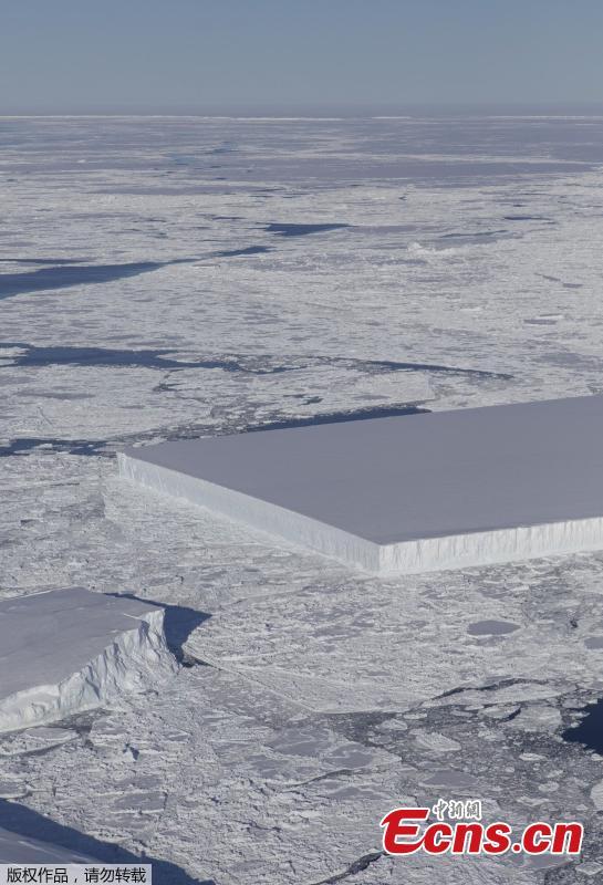 Photo by NASA shows a rectangular iceberg spotted off the east coast of the Antarctic Peninsula, near the Larsen C ice shelf. NASA experts say the sharp angles and flat surfaces are evidence the break occurred very recently. (Photo/NASA)