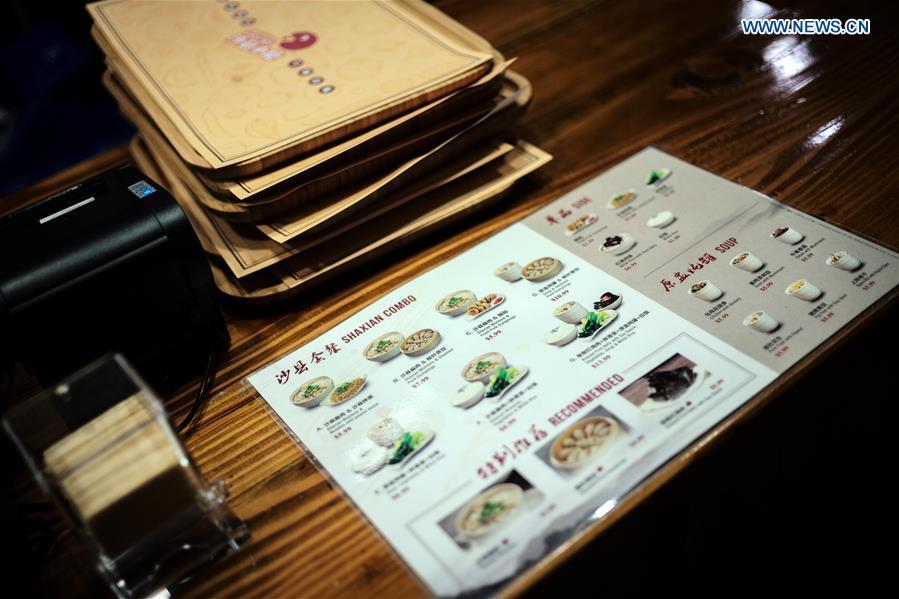 Photo taken on Oct. 21, 2018 shows the menu of Shaxian Snacks restaurant in Brooklyn, New York, the United States. China\'s restaurant chain serving Shaxian County cuisine has opened its first eatery in the United States. Located at 818, 60th St. Brooklyn, the restaurant, which opened Monday, presents overseas foodies with traditional Chinese snacks, including peanut butter noodles and pork wontons. (Xinhua/Li Muzi)
