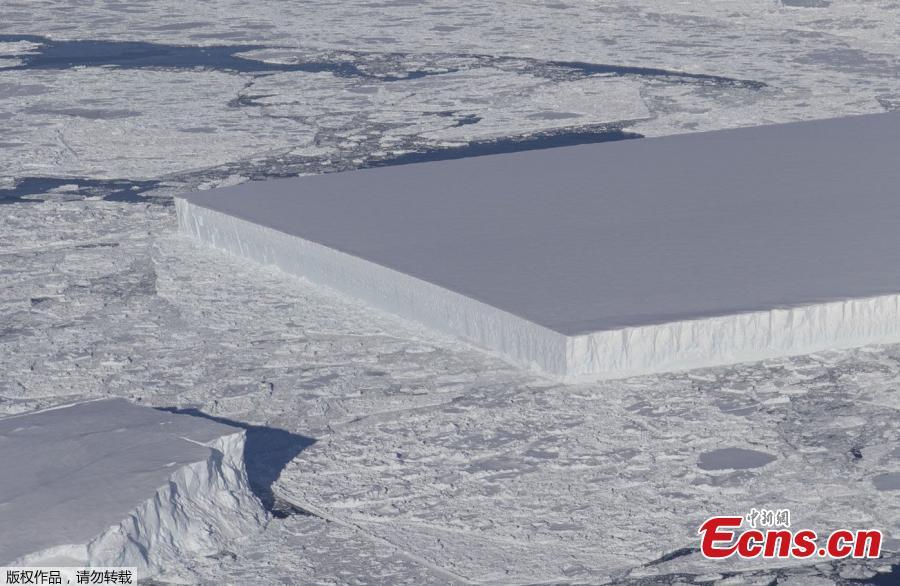Photo by NASA shows a rectangular iceberg spotted off the east coast of the Antarctic Peninsula, near the Larsen C ice shelf. NASA experts say the sharp angles and flat surfaces are evidence the break occurred very recently. (Photo/NASA)
