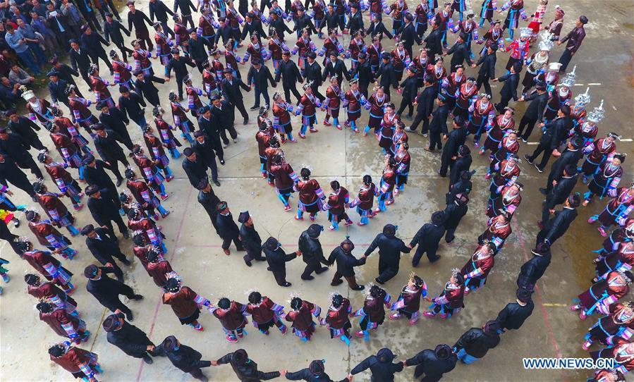 People sing and dance during a harvest festival in Dongtou Village, Rongshui Miao Autonomous County, south China\'s Guangxi Zhuang Autonomous Region, Oct. 26, 2018. Local people celebrated harvest Friday through various activities like fish feast, singing and playing lusheng. (Xinhua/Huang Xiaobang)