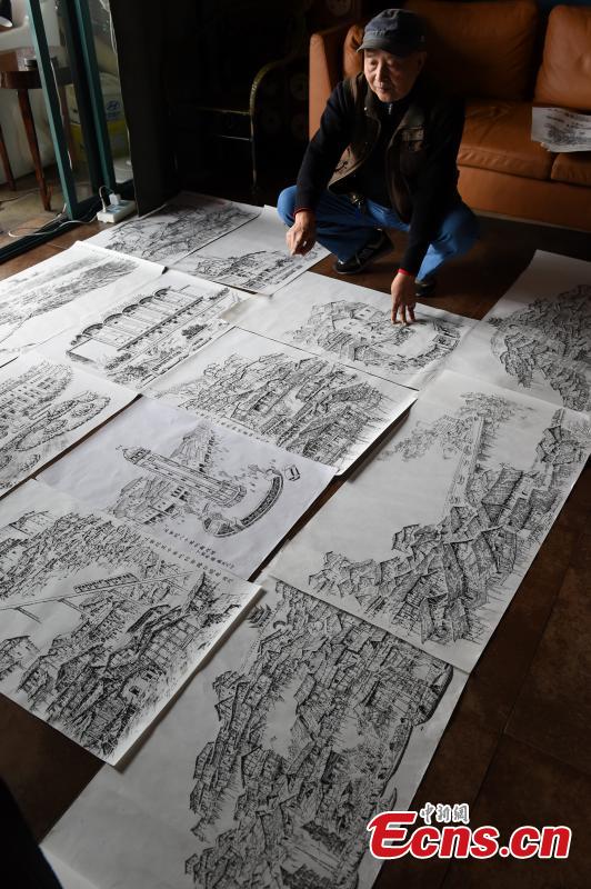 Qin Tingguang, in his seventies, shows his paintings drawn with ink brushes in his home in Southwest China’s Chongqing Municipality, Oct. 29, 2018. Based on his memory, Qin has spent five years drawing 44 paintings of the city’s landmarks 20 years ago. (Photo: China News Service/Zhou Yi)