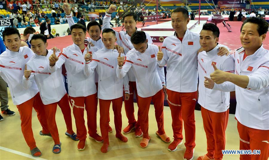 Members of team China celebrate after winning the Men\'s Team Final at the 2018 FIG Artistic Gymnastics Championships in Doha, capital of Qatar, Oct. 29, 2018. Team China won the gold medal. (Xinhua/Nikku)