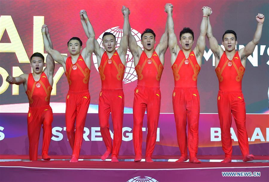 Members of team China celebrate on the podium after winning the Men\'s Team Final at the 2018 FIG Artistic Gymnastics Championships in Doha, capital of Qatar, Oct. 29, 2018. Team China won the gold medal. (Xinhua/Nikku)