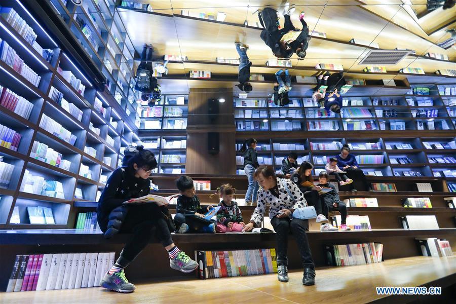 People read at a bookstore named Zhongshuge in Guanshanhu District of Guiyang, southwest China\'s Guizhou Province, Oct. 28, 2018. The design of the bookstore Zhongshuge is inspired by the unique karst landform in Guizhou. (Xinhua/Liu Xu)